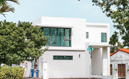 White single wide home with trees on the side